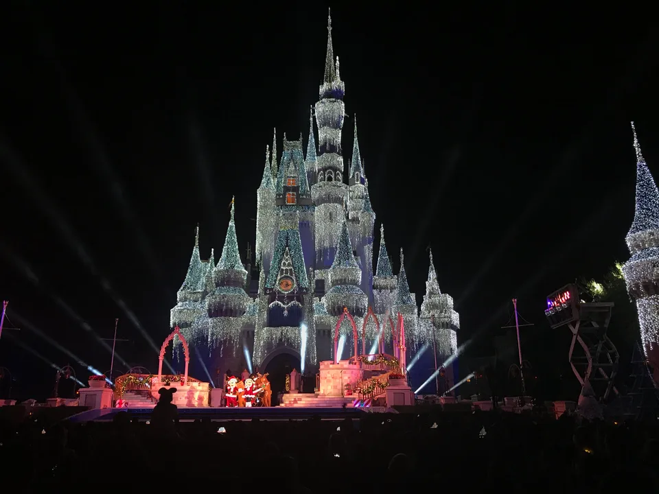 Cinderella Castle covered in holiday lights above the Christmas stage show during Mickey’s Very Merry Christmas Party in November 2018.