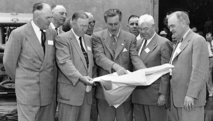 Archival photograph of Walt Disney showing Disneyland plans to Orange County officials in December 1954.